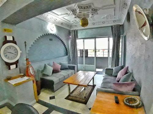 a living room with a couch and a table at Hotel Restaurant Bougafer in Midelt