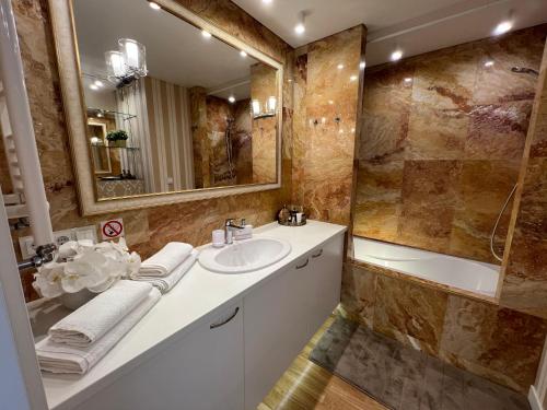 y baño con lavabo y espejo. en Antakalnis 5 stars apartment en Vilna