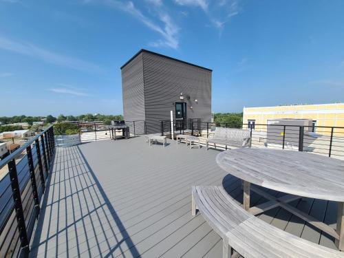 a large deck with a table and benches on a building at 520 Neil Heart of Downtown Champaign in Champaign