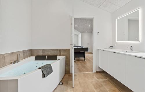 uma casa de banho com uma banheira e um lavatório em 4 Bedroom Pet Friendly Home In Hadsund em Hadsund