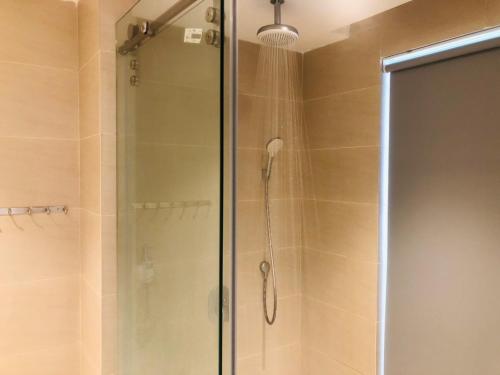 a shower with a glass door in a bathroom at Luxury studio apartment near Nha Trang beach in Nha Trang