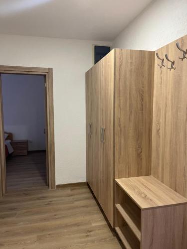 a room with a large wooden cabinet and a hallway at SeaAdrik in Bar