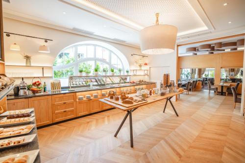 a large kitchen with a table in the middle at Hotel Krone in Mondsee