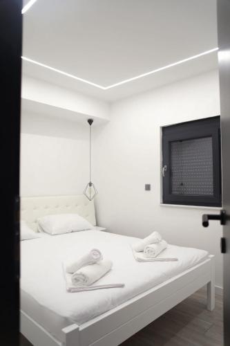 a bedroom with a white bed with towels on it at Elite estate in Podstrana
