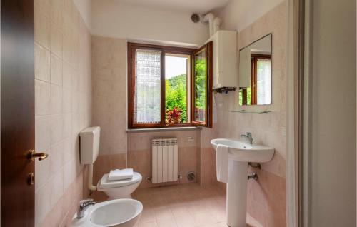 a bathroom with a toilet and a sink and a mirror at Valguerriera - Orzo in Apecchio