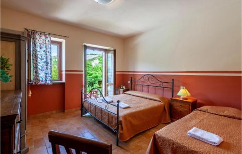 a bedroom with two beds and a window at Valguerriera - Avena in Apecchio