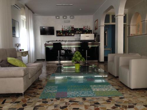 a living room with a couch and a table at Hotel Perugini in Rimini
