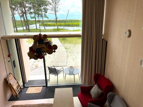 a living room with a view of a patio at KODA Concrete villa by the river with sea view in Papsaare