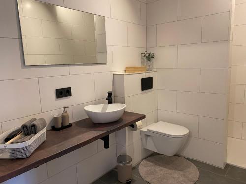 a white bathroom with a sink and a toilet at Apart Zangerle in Fliess