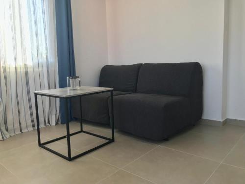a living room with a couch and a table at Guesthouse - Hotel California in Novalja