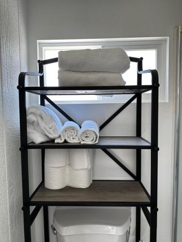 a towel rack with towels and towels on it in a bathroom at Tiny house in the heart of MOVAL private freeparking Netflix in Moreno Valley