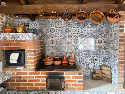 a brick oven with pots and pans on a wall at Hotel RioMiel Tlaxcala in Tlaxcala de Xicohténcatl