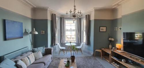 a living room with a couch and a table at Rocky Cove Bed and Breakfast in Ilfracombe