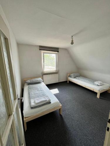a room with two beds and a window at Ferienwohnung / Monteurzimmer in Kitzingen