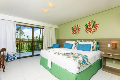 a bedroom with a bed and a balcony at Vivá Porto de Galinhas Resort in Porto De Galinhas