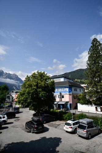 a parking lot with cars parked in front of a building at Ferienwohnung in der Sonnenstadt Lienz in Lienz