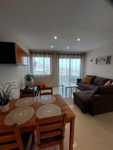 a living room with a table and a couch at Apartamento Vistas Paraiso - Club Paraiso in Adeje