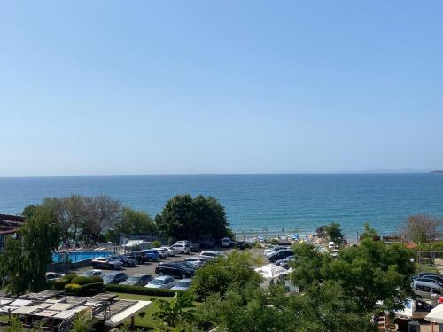a parking lot next to the ocean with cars parked at MARINA BAY 23 Sveti Vlas Beach in Sveti Vlas