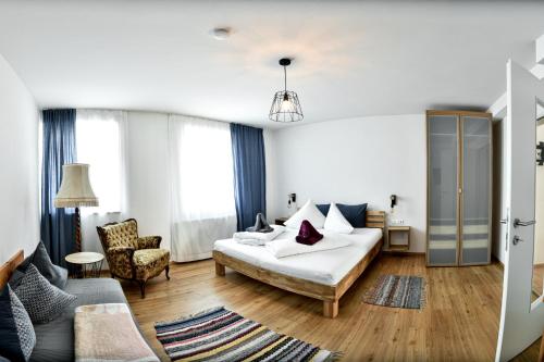 a living room with a bed and a couch at Ferienwohnung in der Sonnenstadt Lienz in Lienz