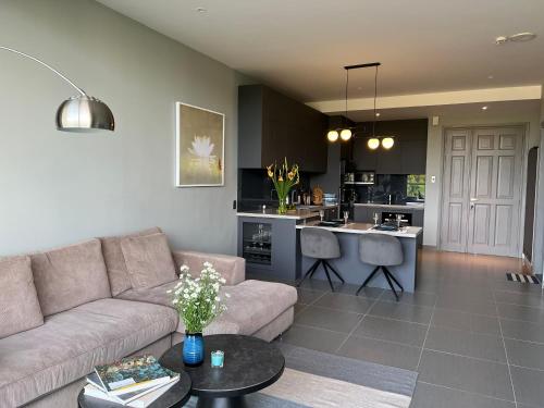 a living room with a couch and a kitchen at Hotel,Căn Hộ Mũi Né Sea link in Phan Thiet