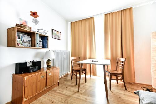 a living room with a table and chairs in a room at Ferienwohnung in der Sonnenstadt Lienz in Lienz