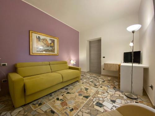 Holiday Home في Belmonte del Sannio: غرفة معيشة مع أريكة صفراء وتلفزيون