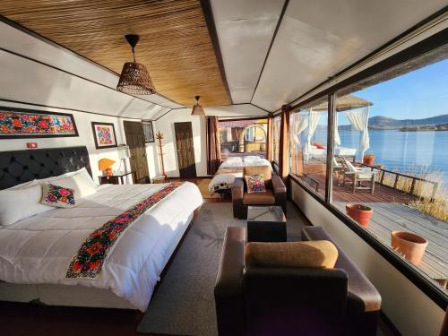 a bedroom with a bed and a view of the water at Casitas del Titicaca Peru in Puno