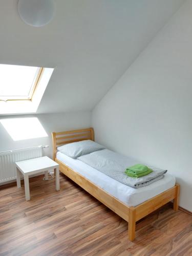 a small bedroom with a bed and a skylight at Eisenstadt Apartments in Eisenstadt