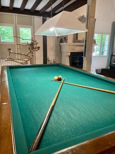 a pool table with balls on top of it at Chambre de la cime des pins in Crévin