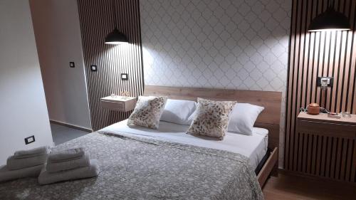 a bedroom with a large bed with two pillows at Garden Suite Apartment in Palermo