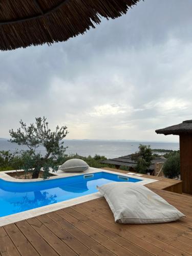 a swimming pool on the deck of a villa at Golden Haven Luxe Bungalow Resort in Murter