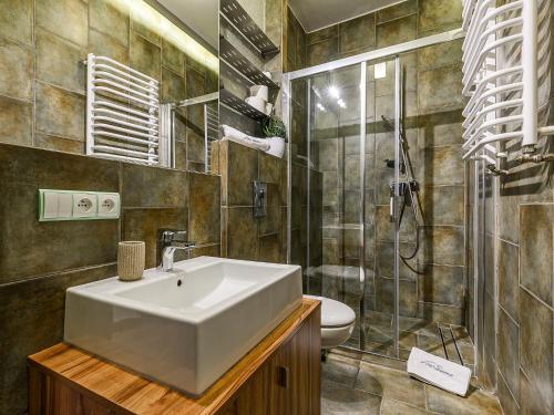 a bathroom with a sink and a shower at VisitZakopane - White Valley Apartment in Zakopane