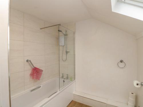 a bathroom with a shower and a tub at Wolds Way in Bainton