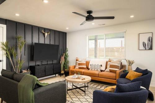 a living room with two couches and a flat screen tv at Wild West Disco Haus 2! New Hot Tub, Patio + Gym in Denver