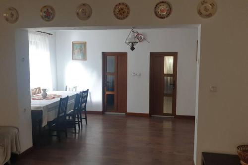 a dining room with a table and chairs in a room at Casă privată in Rozavlea