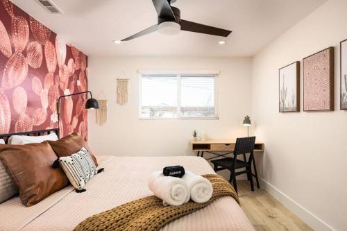 a bedroom with a bed with towels on it at Wild West Disco Haus! New Hot Tub, Patio + Gym in Denver