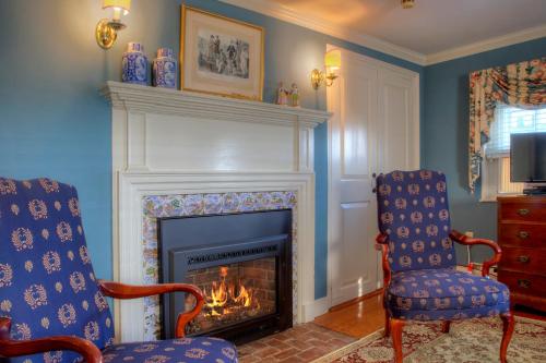 a living room with two chairs and a fireplace at Francis Malbone House in Newport