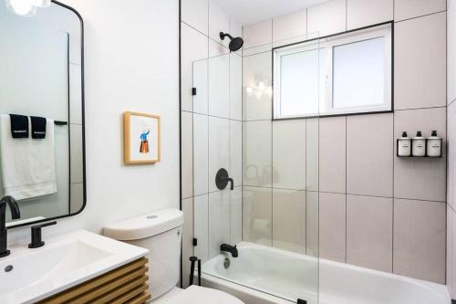a bathroom with a shower and a toilet and a sink at Wild West Disco Haus! Sleeps 12, Hot Tub + Gym! in Denver