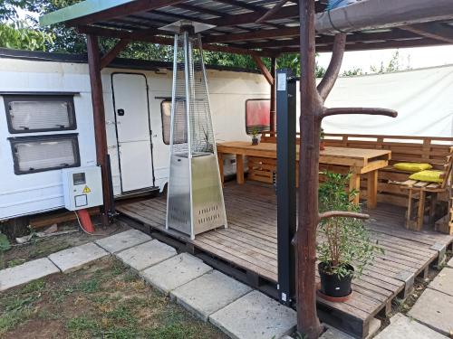 a porch of an rv with a table and a swing at Odpočinek na venkově 