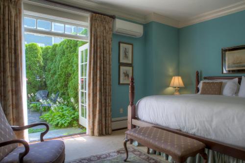 a bedroom with a bed and a large window at Francis Malbone House in Newport