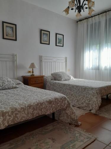 a bedroom with two beds and a window at Casa Concha in Porto do Son