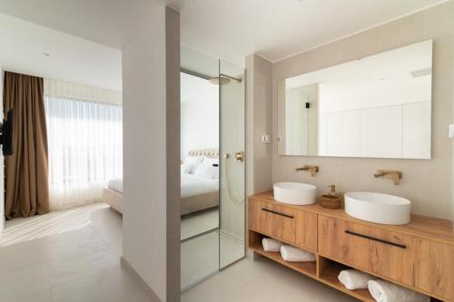 a bathroom with two sinks and a mirror at Villa Aurum in Zadar