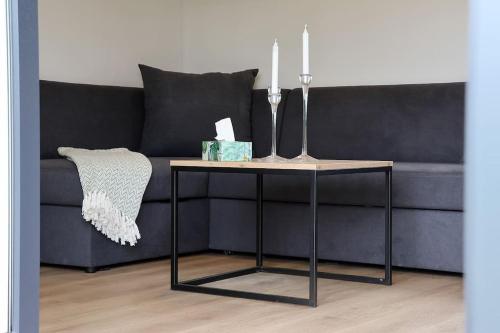 a living room with a couch with a table at Nový mobilheim (srubového typu) in Stropešín