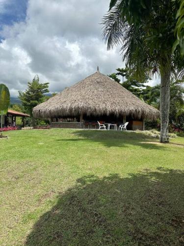 a hut with two white chairs in front of it at increible casa de campo con piscina y jacuzzi! in Támesis