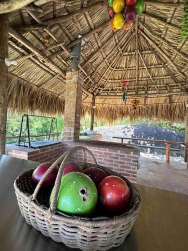 a basket of fruit sitting on a table in a hut at increible casa de campo con piscina y jacuzzi! in Támesis