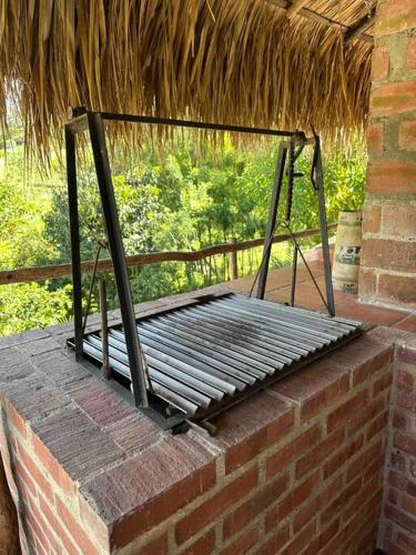 a metal bench sitting on top of a brick wall at increible casa de campo con piscina y jacuzzi! in Támesis