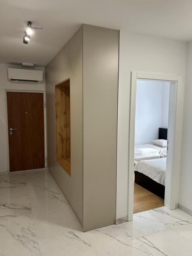 a bedroom with a bed and a sliding glass door at Apartment Marta in Orebić