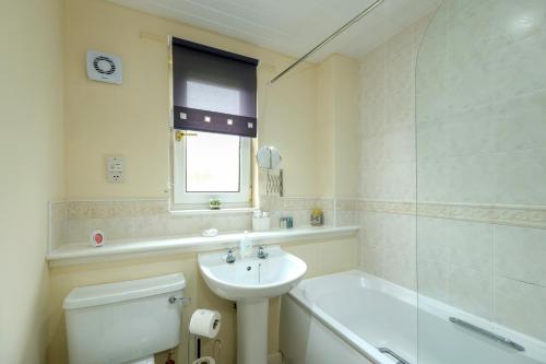 a bathroom with a sink and a toilet and a tub at Pure Apartments Commuter- Dunfermline South in Fife