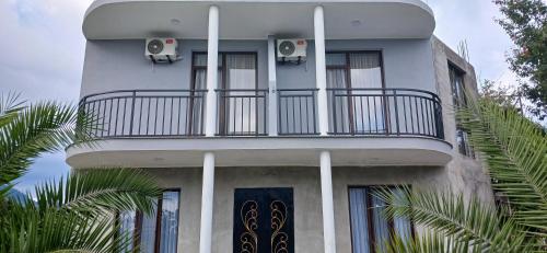 a building with a balcony on the side of it at The best guest house-GAIOZ in Gonio