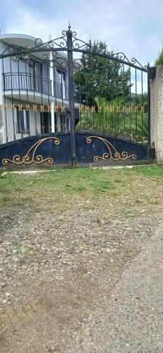 a black and gold gate in front of a house at The best guest house-GAIOZ in Gonio